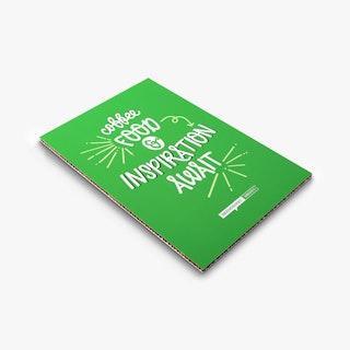 A honeycomb cardboard sign laying flat with a green and white design.