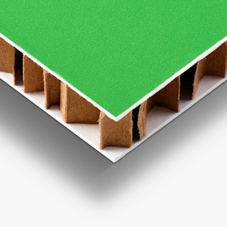 The bottom corner of a honeycomb cardboard sign printed with a green background.