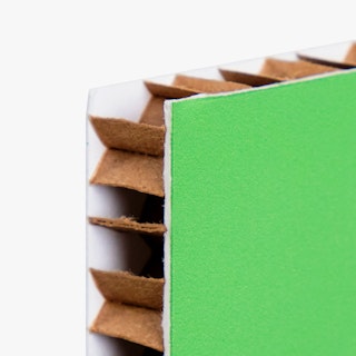 The top corner of a honeycomb cardboard sign printed with a green background.