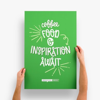 Two hands holding a honeycomb cardboard sign printed with Coffee, Food & Inspiration Await in white.