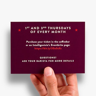A hand holding an invitation printed with a maroon background and details about a brew class in white and red.