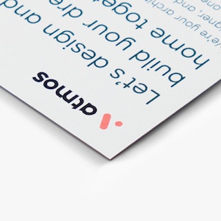 The corner of a calendar magnet printed with Atmos in black and info about building a house.