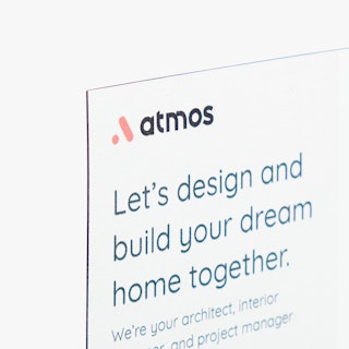The top left corner of a calendar magnet printed with Atmos and info about building a house.