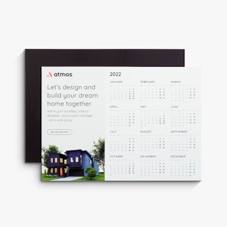 Two magnetic calendars fanned out and printed with Atmos and an image of a house on the front.