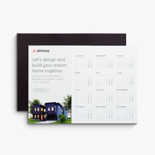 Two magnetic calendars fanned out and printed with Atmos and an image of a house on the front.