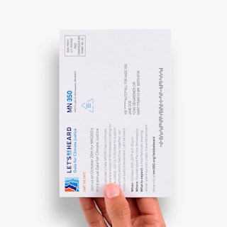 A hand holding a direct mail postcard for the MN 350 nonprofit printed with event info, an address and postage.