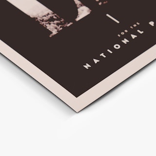 The bottom corner of a custom invite printed with a black background and white border and text.