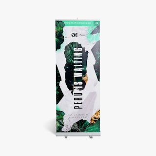 A custom pop up banner printed with Peru Is Waiting and a leaf design with a silver stand.