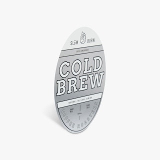 A custom label printed with an oval shape and silver, black and white design.