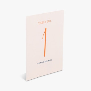 A wedding place card printed with Table No. 1 and #singletoklingel in pink, peach and black.