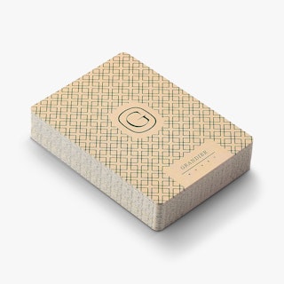 A deck of custom playing cards printed with a green and cream design and Grandier on the back.