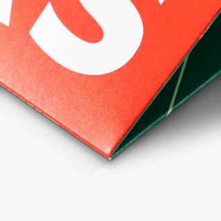 The bottom corner of a pocket folder custom printed in orange, white and green.