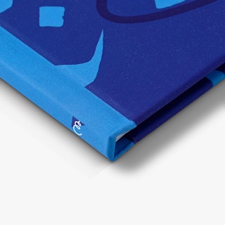 The corner of a photography portfolio with a light and dark blue design on the cover and an E on the spine.