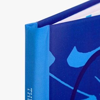 The corner of a hardcover portfolio printed with a light and dark blue design.