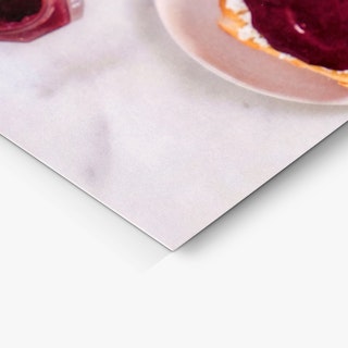 The bottom corner of a custom postcard printed with a light gray marbled background.
