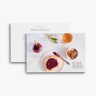 A marketing postcard printed with jam, toast and Rare Bird Preserves overlapping another one.