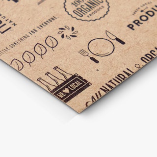 The bottom corner of a custom business card printed on Kraft paper with food and drink graphics in black.