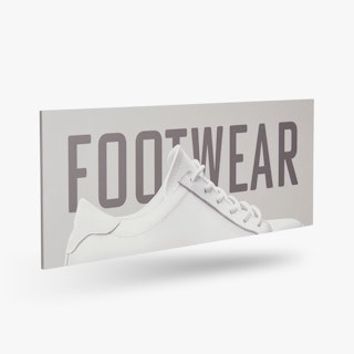 A PVC foam sign custom printed with Footwear in dark gray and a white sneaker.