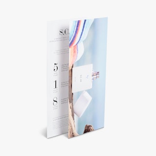 Two custom rack cards overlapping each other and printed with a perfume bottle and scent details.