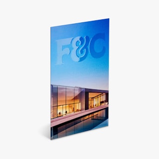 A business card printed with a raised UV coating, F&C and a house with a pool.