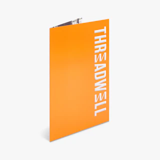 A spot UV pocket folder standing open with an orange design and Threadwell in white.