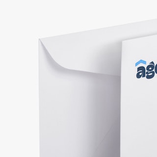 The top left corners of two real estate business envelopes printed with Agent Aaron in blue.