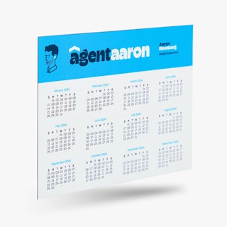 A real estate calendar magnet printed with Agent Aaron in blue and white at the top.