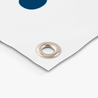 The corner of a white and dark blue hanging banner with a silver grommet.