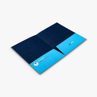 A real estate pocket folder laying open to a dark and light blue interior and agent info on the pockets.