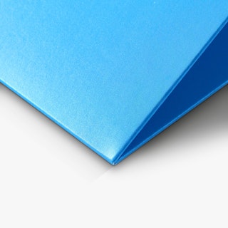 The corner of a pocket folder custom printed in solid blue.