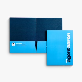 A pocket folder laying open to a dark and light blue interior with another closed folder overlapping it.