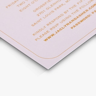 The bottom corner of a reception card printed with a light pink background and details in orange text.