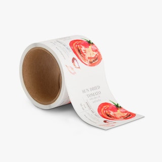 A roll of product labels printed with a tomato illustration and Sun Dried Tomato in black.