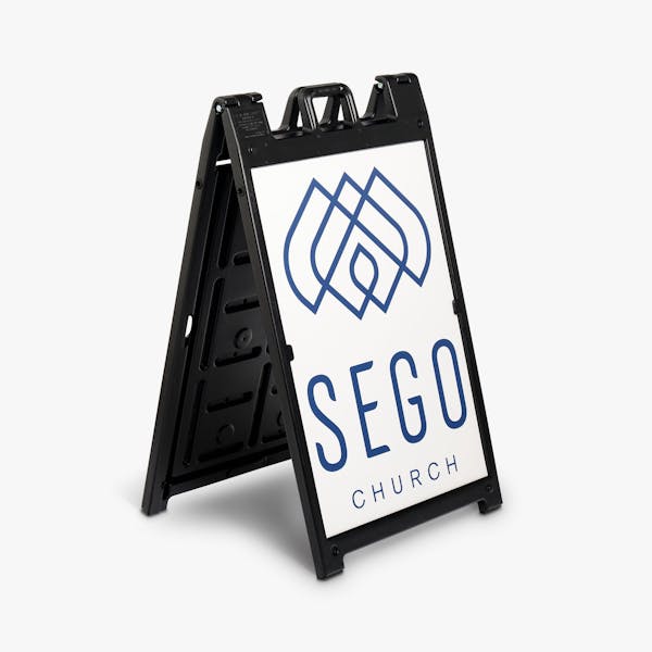 A black A-frame sign holding a sign printed with Sego Church in white and black.