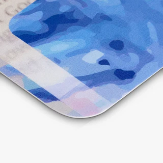 The corner of a custom bookmark printed with a rounded corner and a blue and gray design.