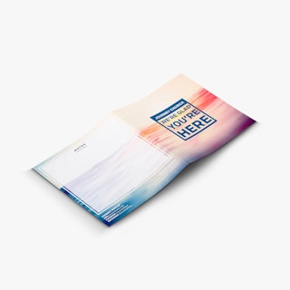A custom brochure laying open and printed with Journey Church We're Glad You're Here on the cover.