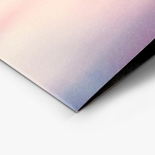 The bottom corner of a custom brochure printed with a watercolor background in orange, pink, blue and purple.