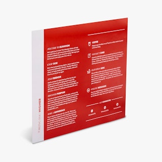 A religious bulletin standing at an angle and printed with a red and white design and worship details.