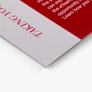 The bottom corner of a church bulletin printed with a red and white design.