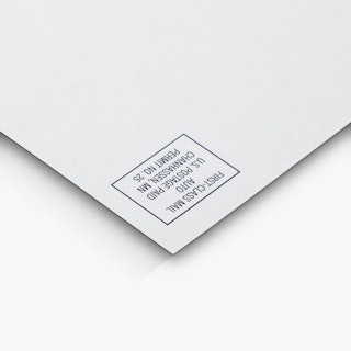 The top right corner of a direct mail postcard printed with first-class postage indicia.