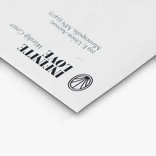 The top left corner of an offering envelope printed with Infinite Love Worship Center and an address.