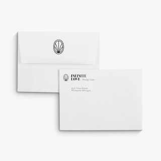 Two church offering envelopes overlapping each other and printed with Infinite Love Worship Center.