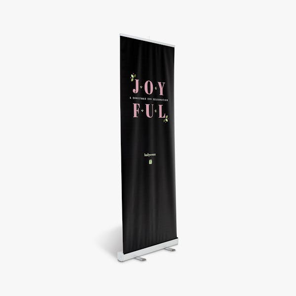 A church retractable banner printed with a black background and Joyful in pink.