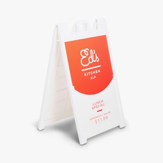 A restaurant sidewalk sign with a white frame and a sign printed with Ed's Kitchen SLP.