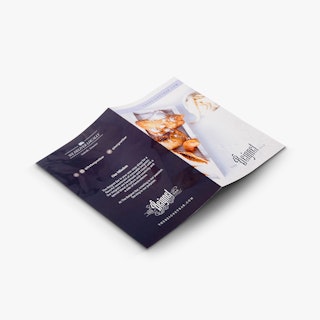 A restaurant brochure laying flat and printed with The Beignet Bar and information about its mission.