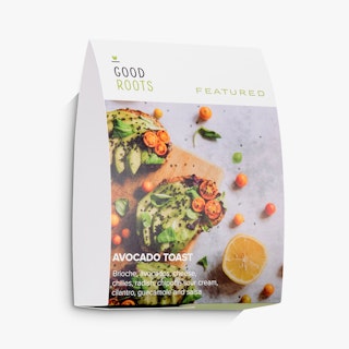 An assembled table tent printed with Good Roots at the top and three pieces of avocado toast.