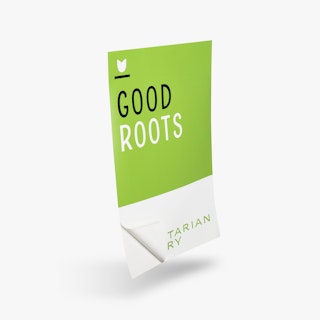 A restaurant wall decal printed with Good Roots in black and white with one corner peeling off the backing.
