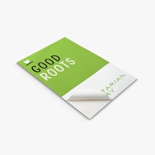 A restaurant wall decal laying flat with Good Roots Vegetarian Eatery and one corner peeling back.