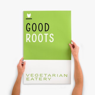 Two hands holding a restaurant wall decal printed with Good Roots in black and white.