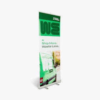 A custom retractable banner printed with a World Express van and a green and white design.